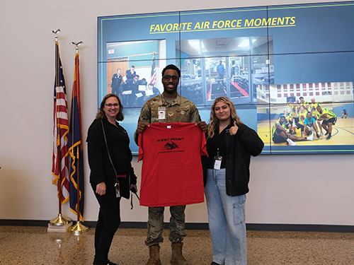 Mrs. Jennifer Cordner and a West Point Leadership Academy student present guest speaker with a special gift