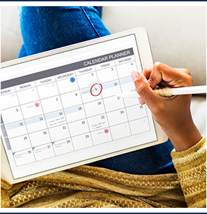 women updating her online calendar via a tablet computer