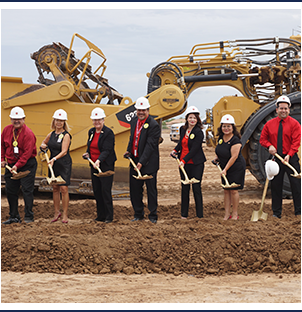 Tolleson Union Leaders with posing for a picture with construction hats and shovels