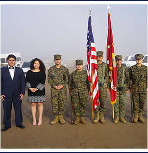 Group of JRROTC students with US and USMC flags along with two students in formal attire